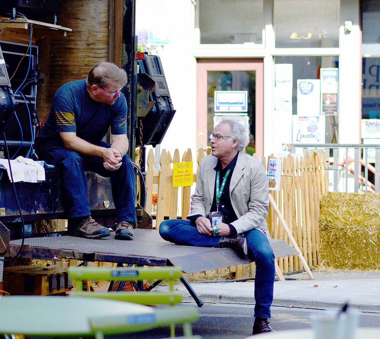 In less restrictive times during the 2019 Port Townsend Film Festival, Rose Theatre owner Rocky Friedman, right, talks with Ted Krysinski of Fyerlite Grip & Lighting. (Diane Urbani de la Paz/for Peninsula Daily News file)
