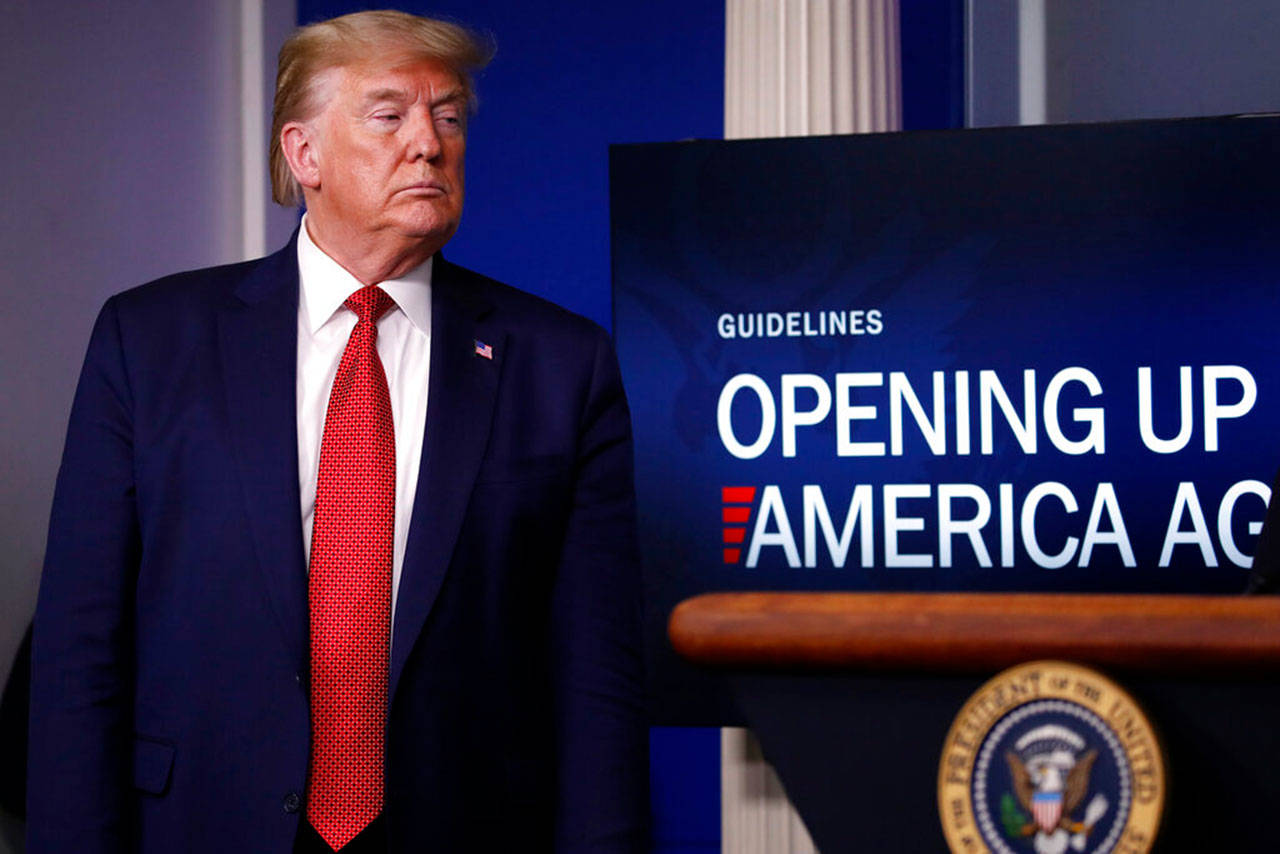 President Donald Trump listens during a briefing about the coronavirus in the James Brady Press Briefing Room of the White House on Thursday, April 16, 2020, in Washington. (Alex Brandon/The Associated Press)