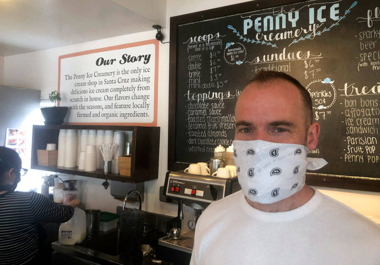 In this April 17, 2020, photo, Zachary Davis poses for a photo at The Penny Ice Creamery in Santa Cruz, Calif. An investigation by The Associated Press hows that many large companies which collectively received tens of millions of dollars in federal loans through the Paycheck Protection Program were at risk of failing even before the coronavirus walloped the economy, while others have acknowledged problems keeping their finances straight and a few have been under investigation by the Securities and Exchange Commission. That big companies and ones with questionable records received such precious financial aid during the chaotic last few weeks frustrates Davis, “We were feeling pretty good about where we were in the world. Now it’s just all turned upside down,” said Davis, who had to lay off 70 workers. (Martha Mendoza/Associated Press)