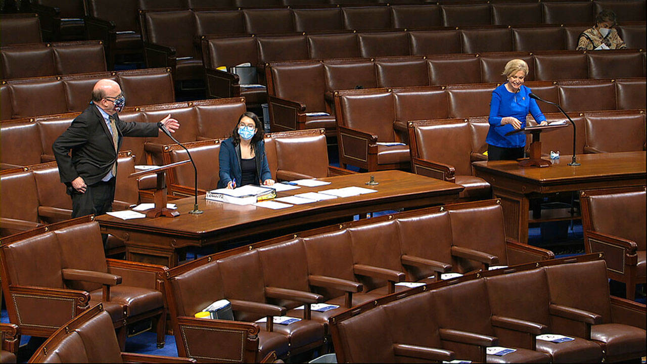 In this image from video, Rep. Jim McGovern, D-Mass., gestures to Rep. Carolyn Maloney, D-N.Y., as they speak on the floor of the House of Representatives at the U.S. Capitol in Washington on Thursday, April 23, 2020. (House Television via AP)