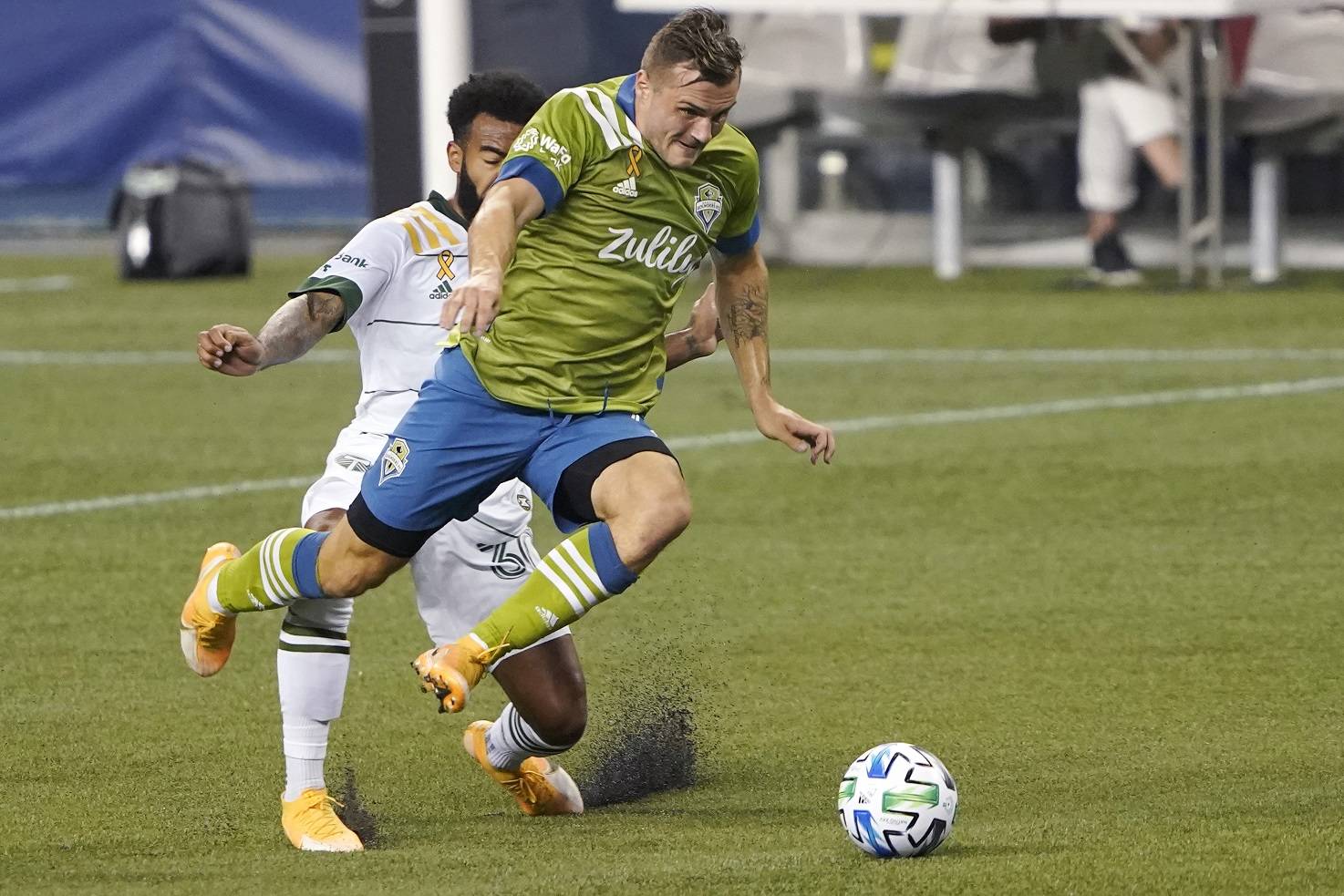 Seattle Sounders forward Jordan Morris gets in front of Portland Timbers midfielder Eryk Williamson to keep control of the ball during the first half of an MLS soccer match Sunday in Seattle. (Ted S. Warren/Associated Press)