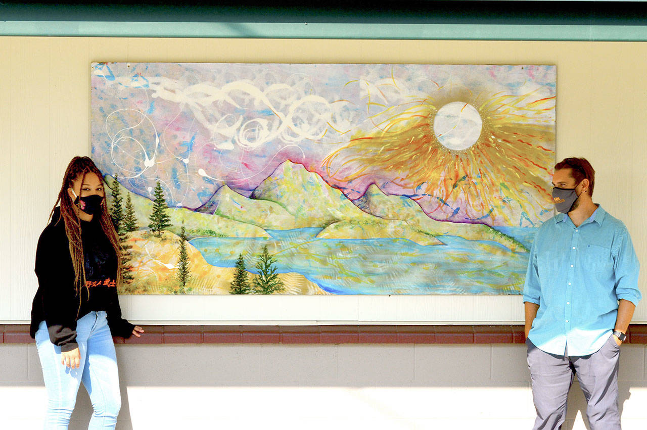 Artist Olivia Benson and teacher Jake Reichner are delighted with the new mural at Quilcene School. (Diane Urbani de la Paz/for Peninsula Daily News)