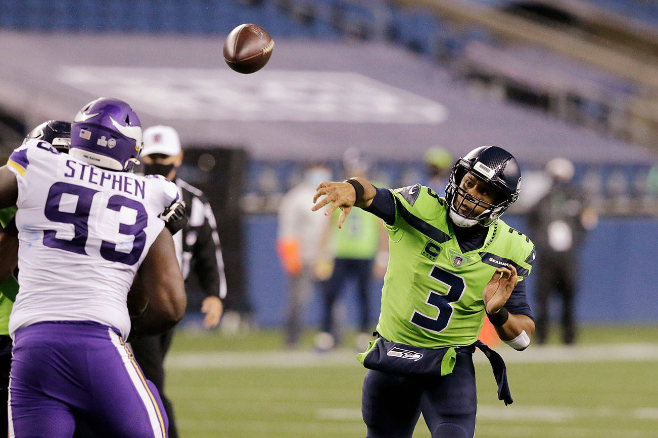 Seattle Seahawks quarterback Russell Wilson throws against the Minnesota Vikings during the second half of an NFL football game, Sunday, Oct. 11, 2020, in Seattle. (AP Photo/John Froschauer)