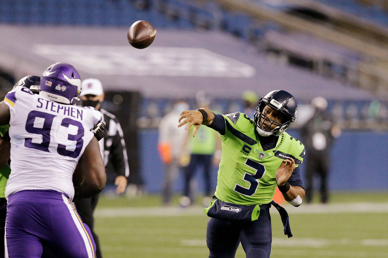 Seattle Seahawks quarterback Russell Wilson throws against the Minnesota Vikings during the second half of an NFL football game Sunday, Oct. 11, 2020, in Seattle. (John Froschauer/Associated Press)