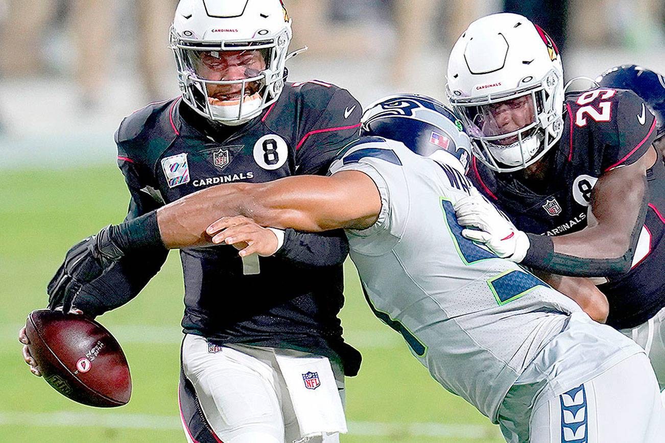 Arizona Cardinals quarterback Kyler Murray avoids the sack as Seattle Seahawks middle linebacker Bobby Wagner, right, makes the hit during the first half of an NFL football game, Sunday, Oct. 25, 2020, in Glendale, Ariz. (AP Photo/Ross D. Franklin)