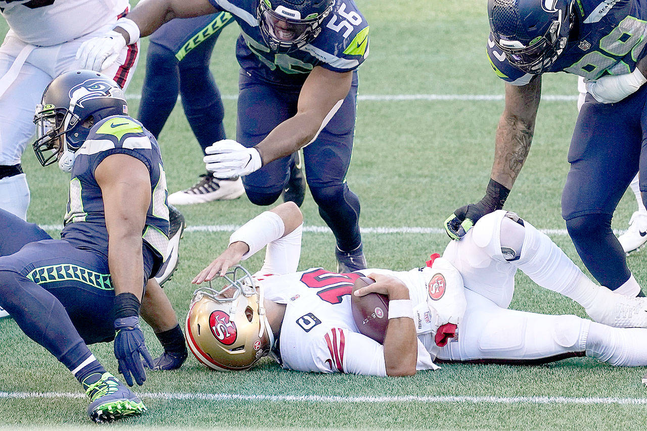 San Francisco 49ers quarterback Jimmy Garoppolo reacts after he was sacked by Seattle Seahawks middle linebacker Bobby Wagner during the first half Sunday, Nov. in Seattle. Garoppolo was later knocked out of the game. (Elaine Thompson/Associated Press)