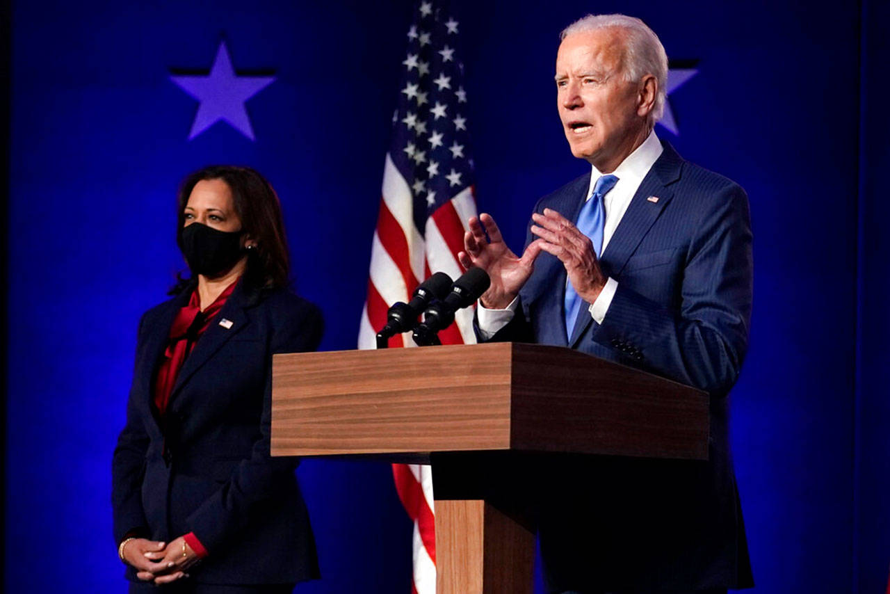 Democratic vice presidential candidate Sen. Kamala Harris, D-Calif., listens as Democratic presidential candidate former Vice President Joe Biden speaks Friday, Nov. 6, 2020, in Wilmington, Del. (Carolyn Kaster/Associated Press)