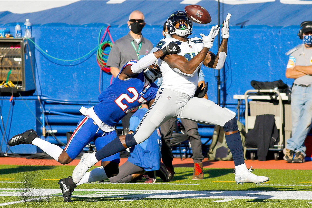 Seattle Seahawks’ DK Metcalf (14) catches a pass in front of Buffalo Bills’ Tre’Davious White (27) during the first half of an NFL football game Sunday, Nov. 8, 2020, in Orchard Park, N.Y. (AP Photo/Jeffrey T. Barnes)