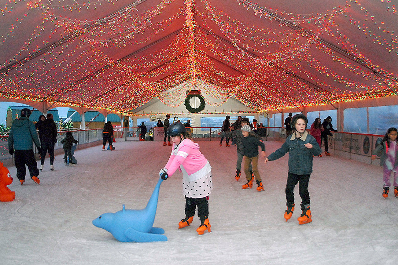 Skaters make their way around the rink of the Port Angeles Ice Village in November 2019. (Keith Thorpe/Peninsula Daily News)