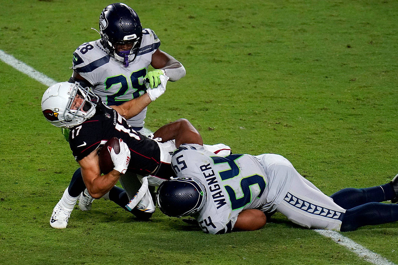 Arizona Cardinals wide receiver Andy Isabella (17) is hit by Seattle Seahawks middle linebacker Bobby Wagner (54) during the second half of an NFL football game, Sunday, Oct. 25, 2020, in Glendale, Ariz. (AP Photo/Ross D. Franklin)