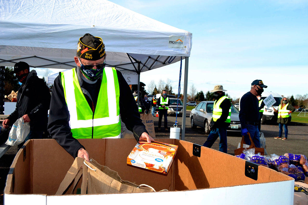 Volunteers like Calvin Barnard, senior vice commander of Carlsborg VFW Post 6787, helped distribute food at the Family Holiday Meal Bay program Nov. 20, 2020. Dozens of volunteers return Dec. 18 to help provide food for Christmas. (Matthew Nash/Olympic Peninsula News Group)