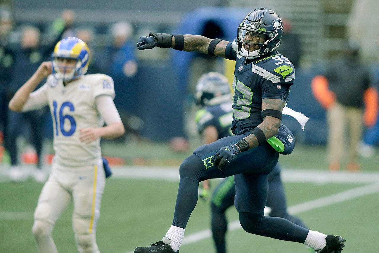 Seattle Seahawks strong safety Jamal Adams (33) reacts to a play with Los Angeles Rams quarterback Jared Goff (16) in the background, during the second half of an NFL football game, Sunday, Dec. 27, 2020, in Seattle. (Scott Eklund/The Associated Press)