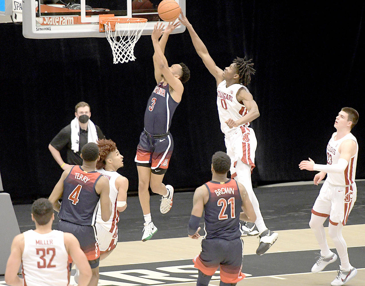 Washington State center Efe Abogidi (0) blocks a shot by Arizona guard Jemarl Baker Jr. (3) on Jan. 2 in Pullman. (Dean Hare/The Associated Press)