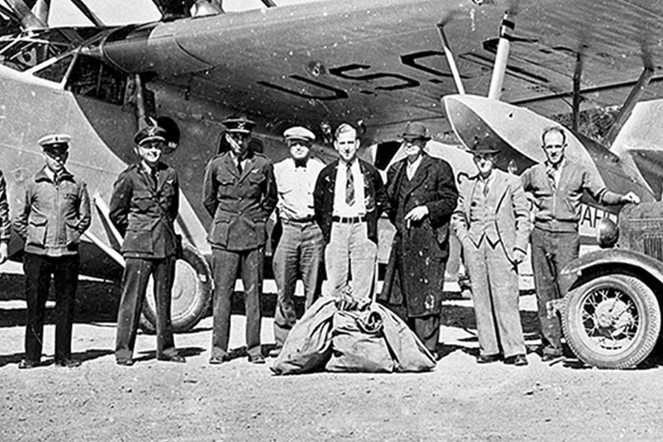 A USCG Douglas RD-4, post office truck and unidentified men gather at Cook’s Prairie, the location of the current William R. Fairchild International Airport in Port Angeles. (Courtesy of Bert Kellogg Collection/North Olympic Library System)