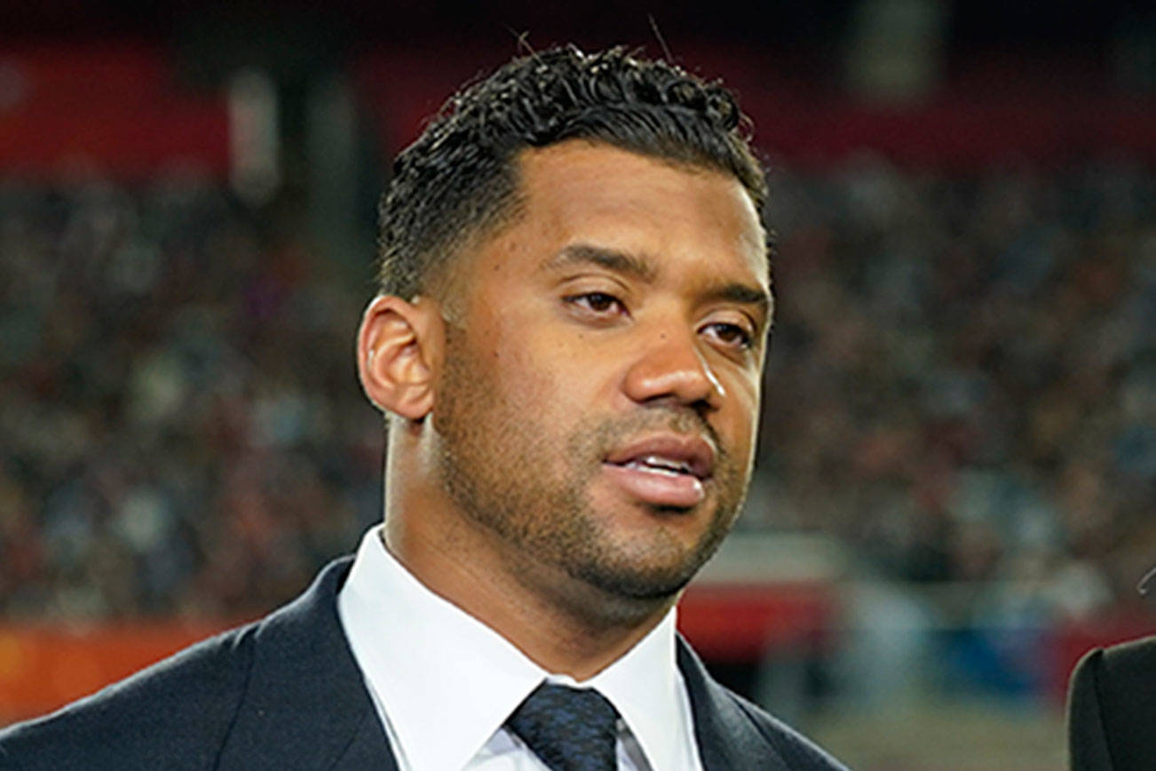 Seattle Seahawks quarterback Russell Wilson and his wife, Ciara, make a statement after Wilson won the Walter Payton NFL Man of the Year award at the NFL Honors ceremony as part of Super Bowl 55 on Feb. 5 in Tampa, Fla. (Charlie Riedel/The Associated Press)
