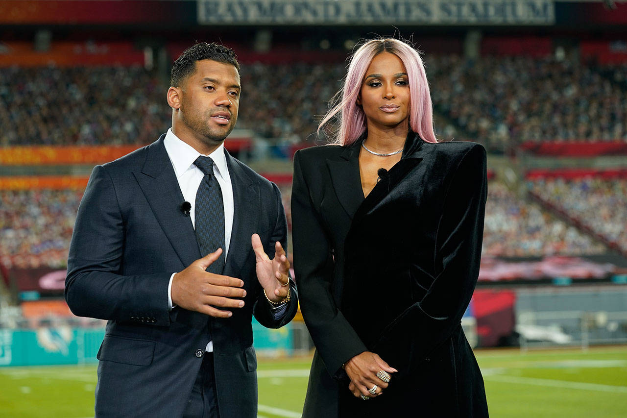 Seattle Seahawks quarterback Russell Wilson and his wife, Ciara, make a statement after Wilson won the Walter Payton NFL Man of the Year award at the NFL Honors ceremony as part of Super Bowl 55 on Feb. 5 in Tampa, Fla. (Charlie Riedel/The Associated Press)