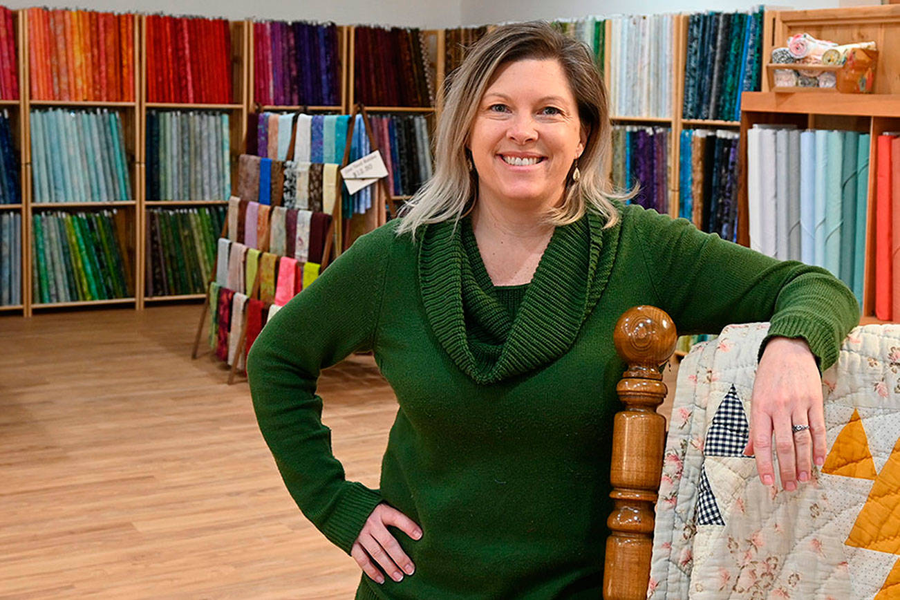Nicole Driggs stands inside A Stitch in Time Quilt Shoppe, which opened last week on the 200 block of East Washington Street. Michael Dashiell/Olympic Peninsula News Group