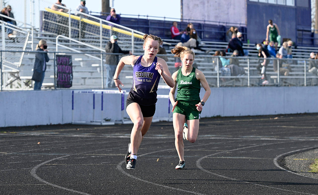 Sequim’s Riley Pyeatt, left, and Port Angeles’ Lauren Larson race during the 800-meter run at a track meet held in Sequim on Wednesday. Larson won the 800 and the 1,600 run while Pyeatt claimed the 100- and 400-meter races. (Michael Dashiell/Olympic Peninsula News Group)