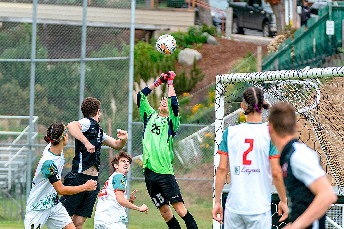 Steve Mullensky/for Peninsula Daily News

Northern Peninsula Football Club keeper, Hayden Price, #25, makes the save during a semi-pro match on Sunday against the Gala FC from Mill Creek played in Port Townsend's memorial Field. Teammates Silas DeWyse, 14, Raul Medina, 21 and Trillium DeWyse, 2, look on.