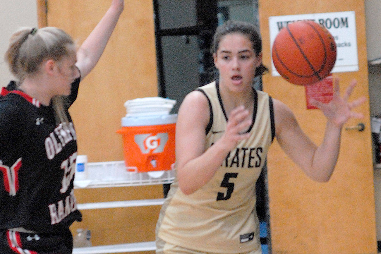Peninsula’s Hope Glasser, a graduate of Sequim High School, right, tries to slip around the defense of Olympic’s Jasmani Apker-Montoya, a Port Townsend High School graduate, during Saturday’s game in Port Angeles. (Keith Thorpe/Peninsula Daily News)