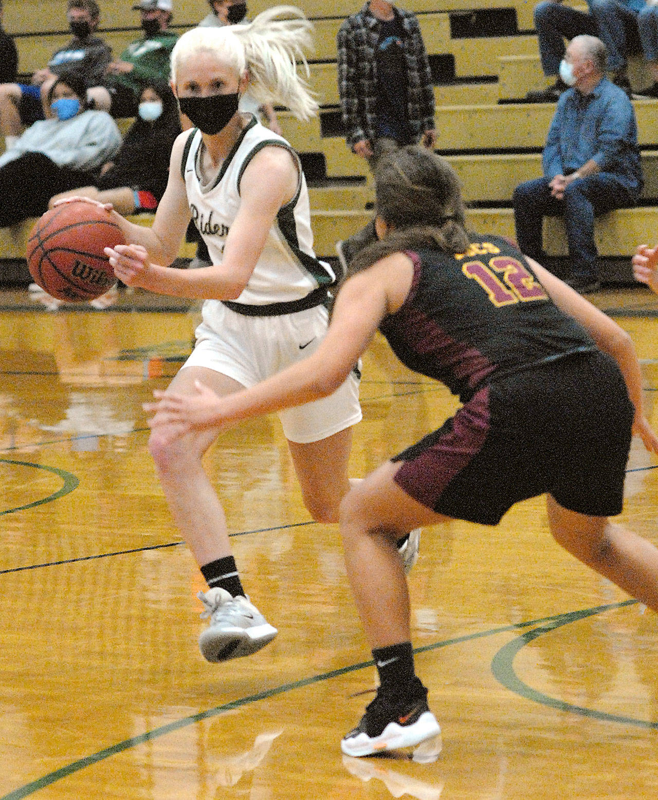 Port Angeles Millie Long, left. drives around Kingstons Brianna Jorgensen in Port Angeles in May. Long was named the Olympic League 2A girls MVP. (Keith Thorpe/Peninsula Daily News)