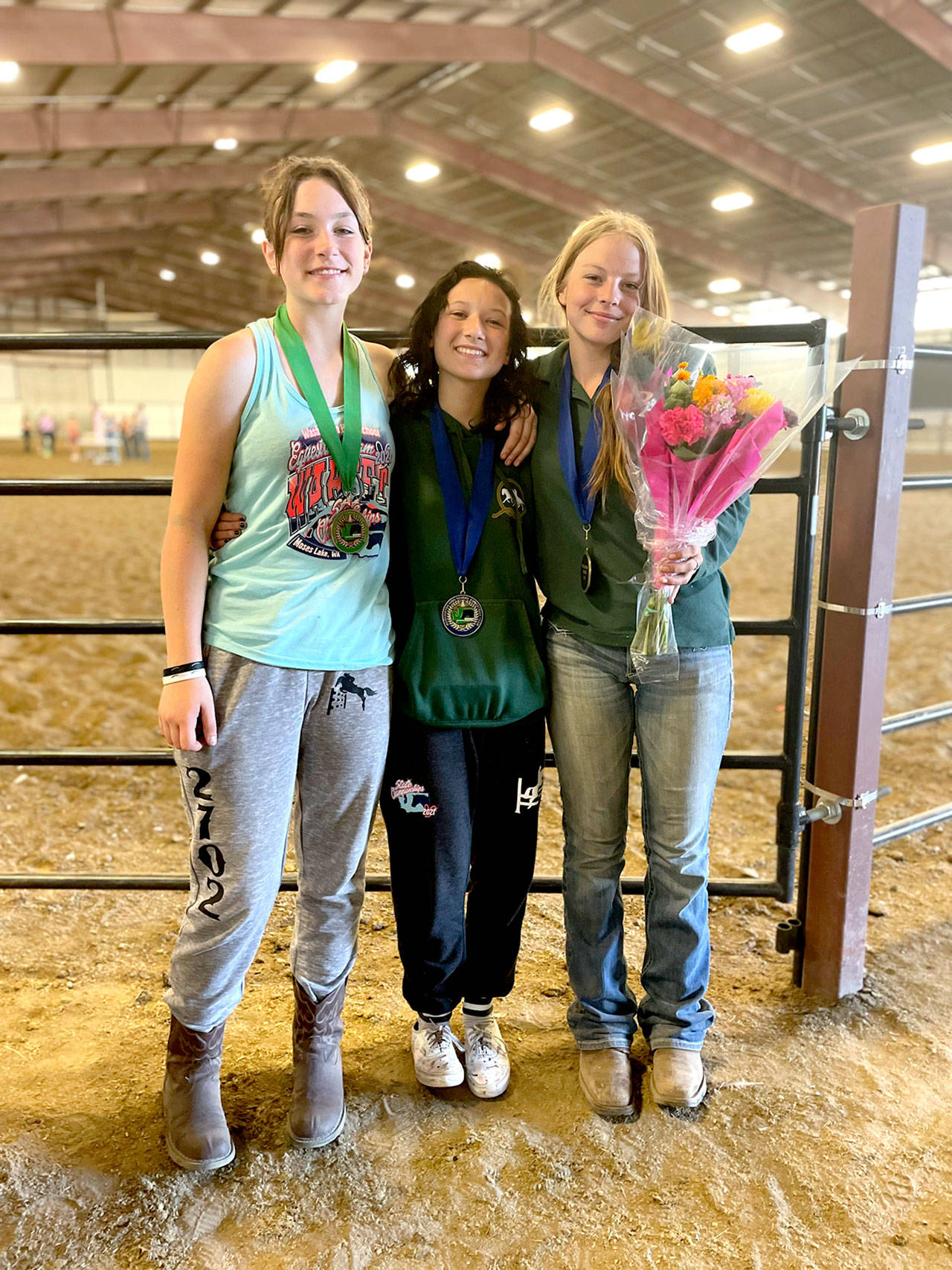 Members of Port Angeles High School’s equestrian team wond medals at WAHSET State Finals last weekend in Moses Lake. Sara Holland, left, won the bronze and Sydney Hutton, center, won gold medal in hunt seat equitation over fences while Amelia Kinney, right, won gold in breakaway roping. (Photo courtesy Katharyn Rivers.)