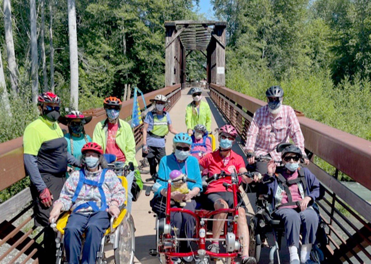 Members of the Sequim Wheelers break out all four of the nonprofit’s adaptive bikes for the first time on June 21, the first day of summer. (Photo by Tom Coonelly)