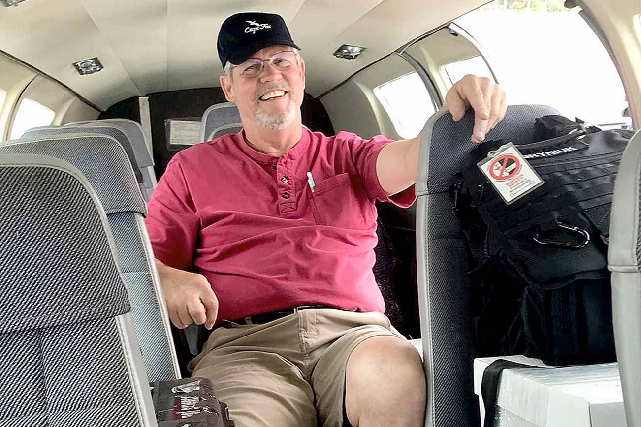 Retired pilot Josh Crabtree of Port Angeles sits in a Dash Air Shuttle Cessna 402c that he helped fly from the East Coast in June. The plane would be used for passenger flights from Fairchild International Airport in Port Angeles to Sea-Tac International Airport. (Paul Gottlieb/Peninsula Daily News)