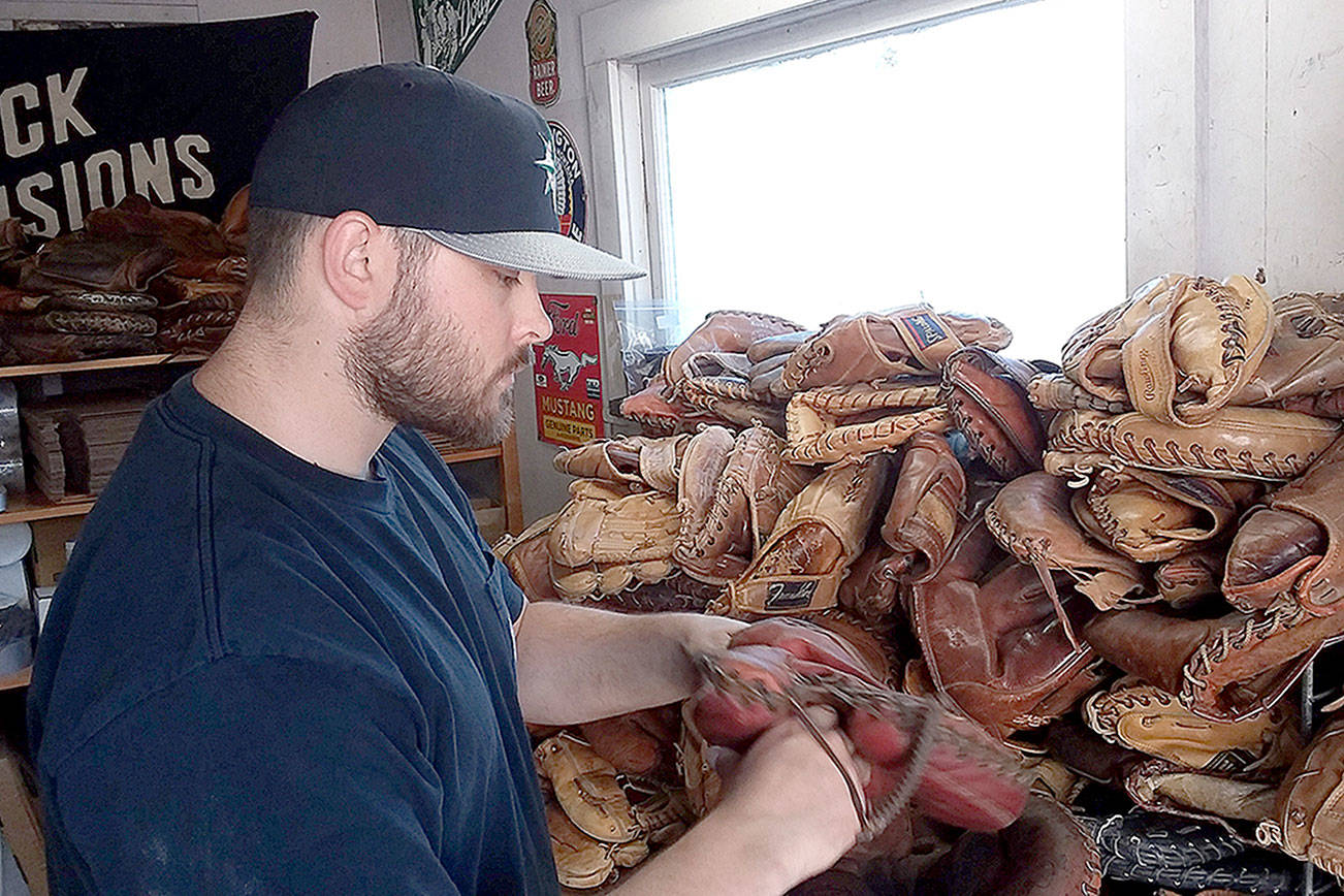 Pierre LaBossiere/Peninsula Daily News
KC Mack of Port Angeles has at least 500 old baseball gloves in his workshed for his business of turning gloves into wallets and other leather items.