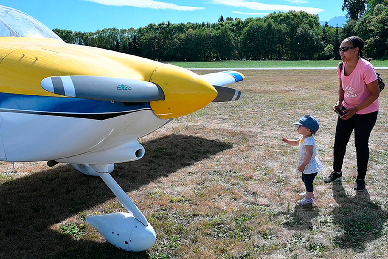 Kendall Huff and nearly-2-year-old Kenna Huff of Snohomish get an up-close look at an RV-9A homebulit aircraft at the eighth Olympic Peninsula Air Affaire and Fly-In on Saturday afternoon in Sequim. This year’s show, reduced to a one-day fest, featured helicopter and airplane rides, dozens of airplanes, classic cars and remote control airplane demonstrations at the Sequim Valley Airport. (Michael Dashiell/Olympic Peninsula News Group)