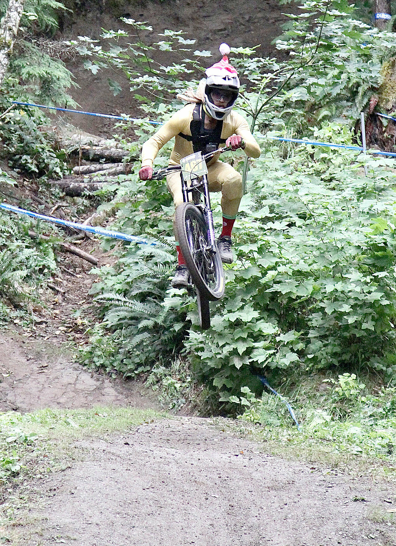 Blake Nelson of Wenatchee, wearing a Santa cap, flies down the course at Dry Hill on Sunday. Nelson finished second in the 30-39 age bracket. (Dave Logan/for Peninsula Daily News)