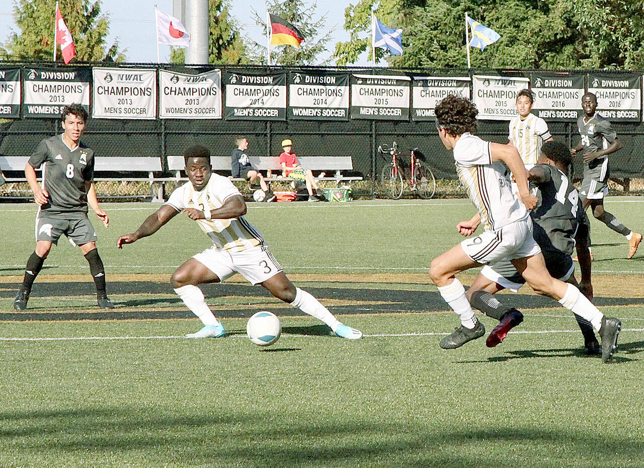 Peninsula College’s Theodore Baiye, left, and Nicolas Hernandez work the ball upfield during the Pirates’ 2-0 win over the Titans on Wednesday at Wally Sigmar Field. (Dave Logan/for Peninsula Daily News)