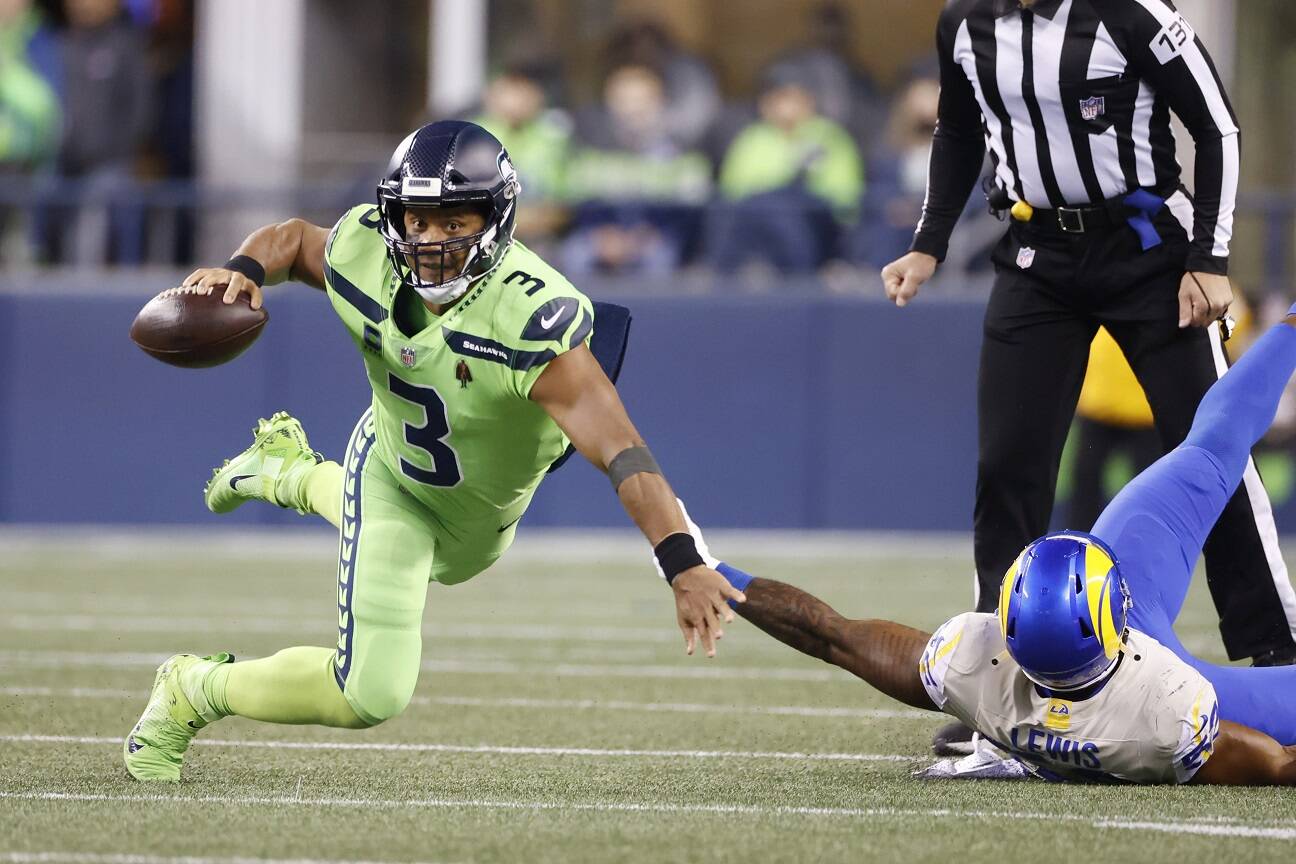 Seattle Seahawks quarterback Russell Wilson goes down as he tries to get a pass off against the Los Angeles Rams during the second half Thursday in Seattle. (Craig Mitchelldyer/The Associated Press)