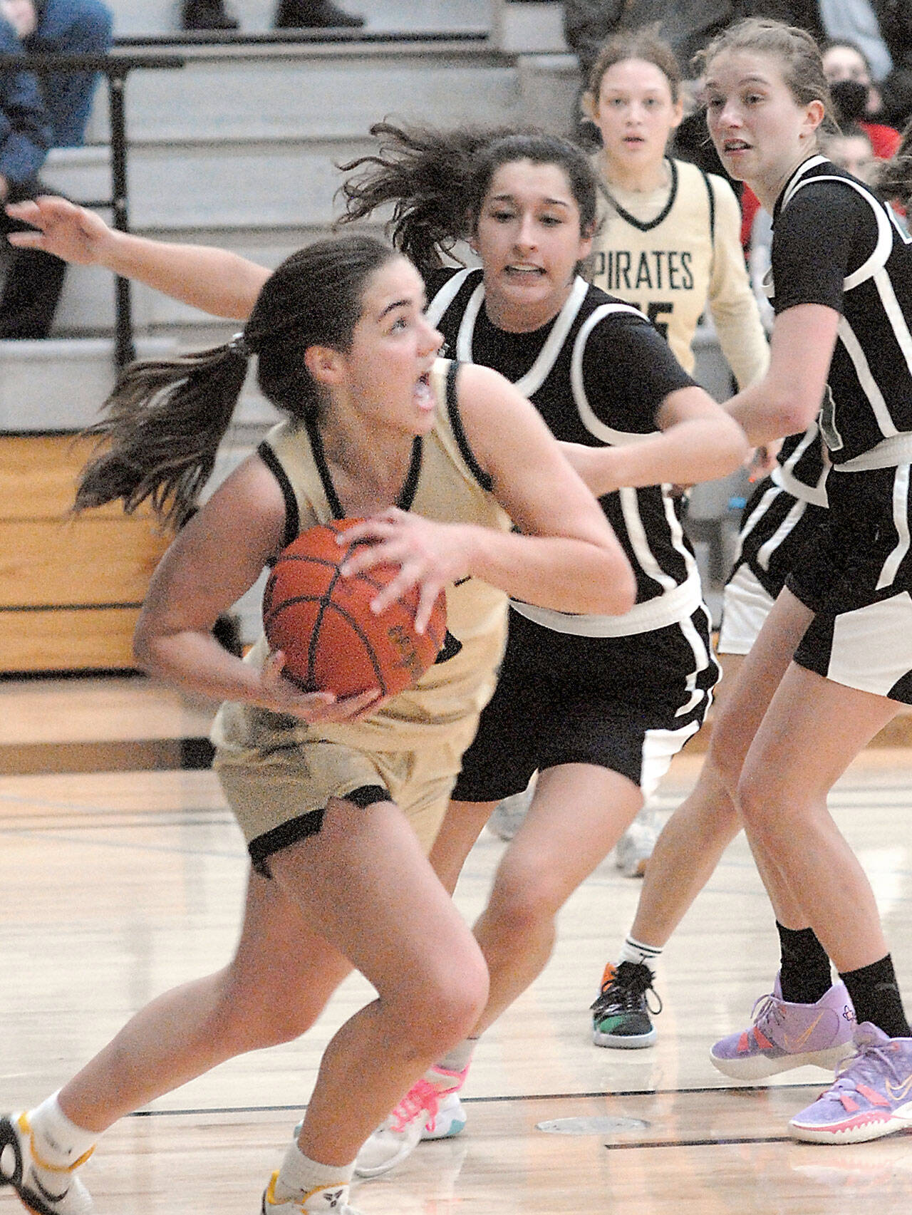 Keith Thorpe/Peninsula Daily News Peninsula’s Hope Glasser, front, looks for the basket while defended by Chemeketa’s Marri-Ann Martinez and Erin Counts, right, during Saturday’s game in the Pirate Classic tournament in Port Angeles. Looking on is Glasser’s teammate Madison Cooke.