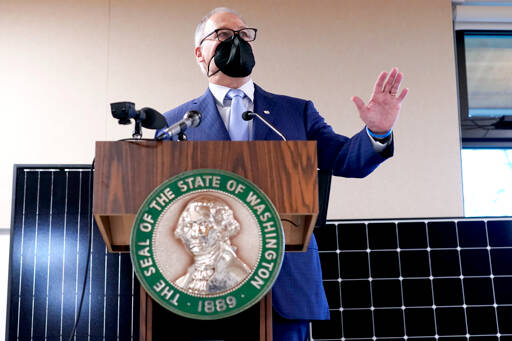 Ted S. Warren / The Associated Press
Gov. Jay Inslee announces several climate-related proposals for the 2022 legislative session during a news conference Monday in Olympia, including a plan to offer rebates on new and used electric vehicles.
