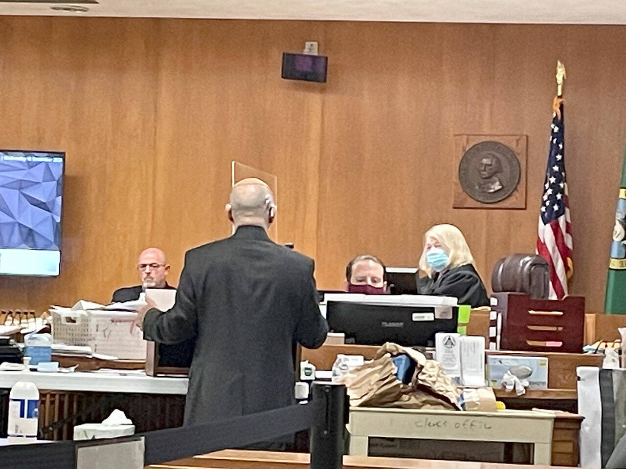 State Patrol Detective Michael Grall, left, is questioned by Clallam County Deputy Prosecuting Attorney Jesse Espinoza in Dennis Marvin Bauer’s triple-murder trial in Clallam County Superior Court. (Rob Ollikainen/for Peninsula Daily News)