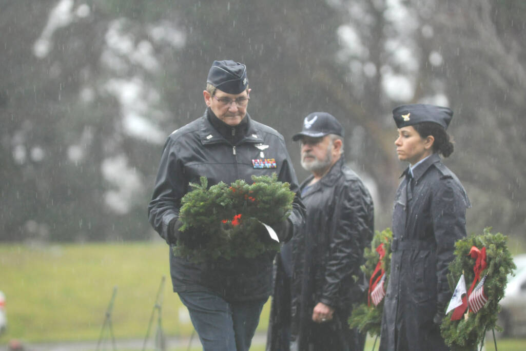 Lt. Col. Susan Sorensen (ret.) prepares to lay a ceremonial wreath honoring those who served in the U.S. Coast Guard. (Michael Dashiell/Olympic Peninsula News Group)