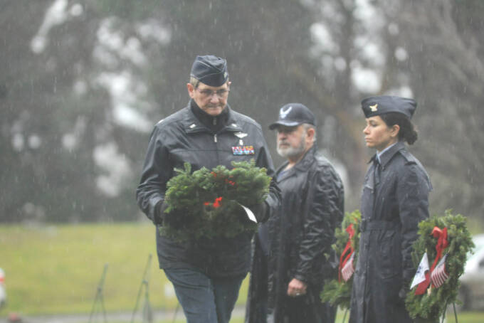Lt. Col. Susan Sorensen (ret.) prepares to lay a ceremonial wreath honoring those who served in the U.S. Coast Guard. (Michael Dashiell/Olympic Peninsula News Group)