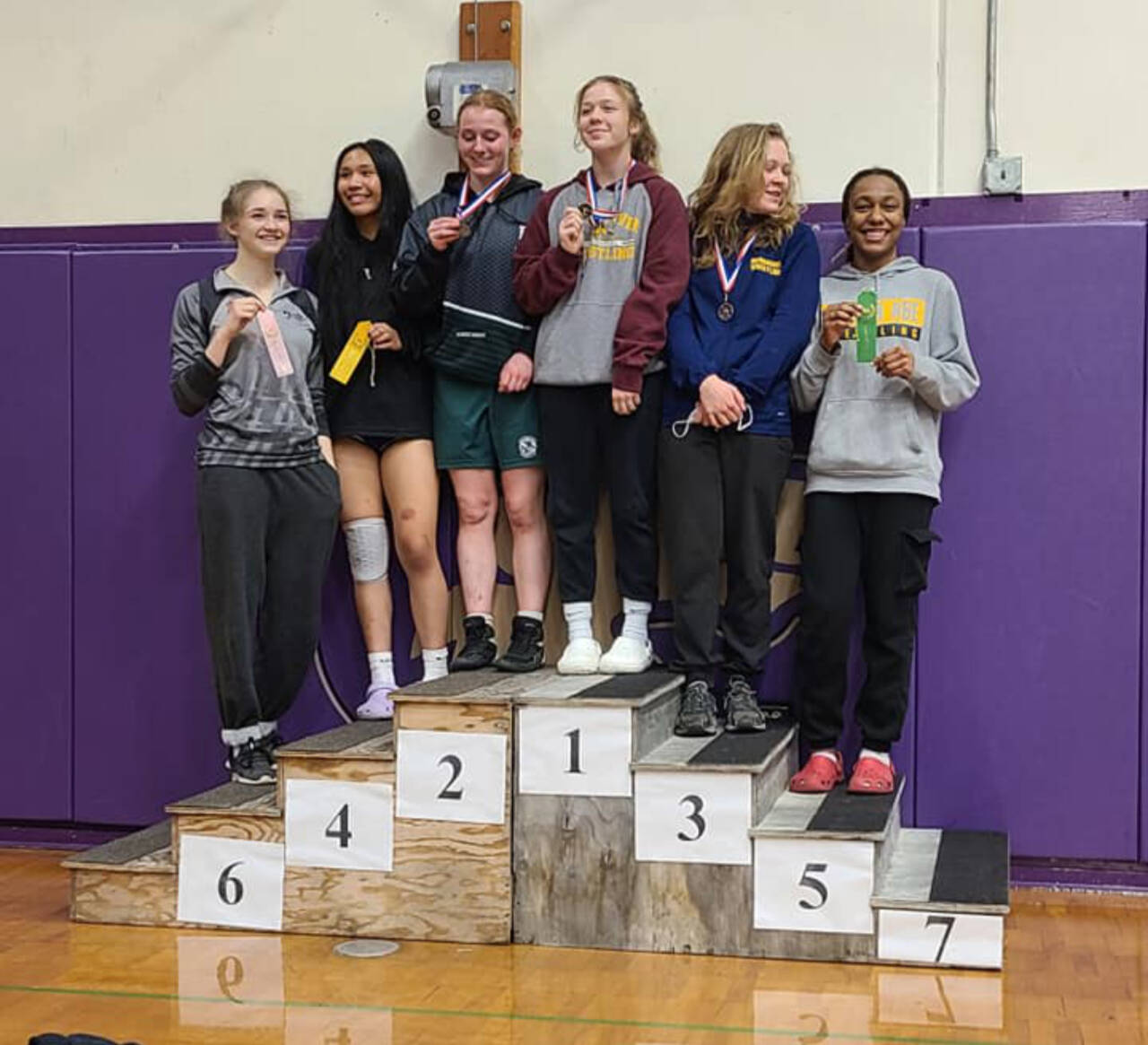 Photo courtesy of Rob Gale Members of the Port Angeles girls wrestling team celebrate finishing sixth out of 30 teams at subregionals held Saturday at Sequim High School. The girls finished with 94 points and were just seven points out of third. From left, are Ada Oberwarth, Charlize Pasco, Kennedy Bruch, Shelby Moore, Alexandra Morrison and Heavenly King. Bruch finished second in her 130-pound weight division, making it to the championship round.