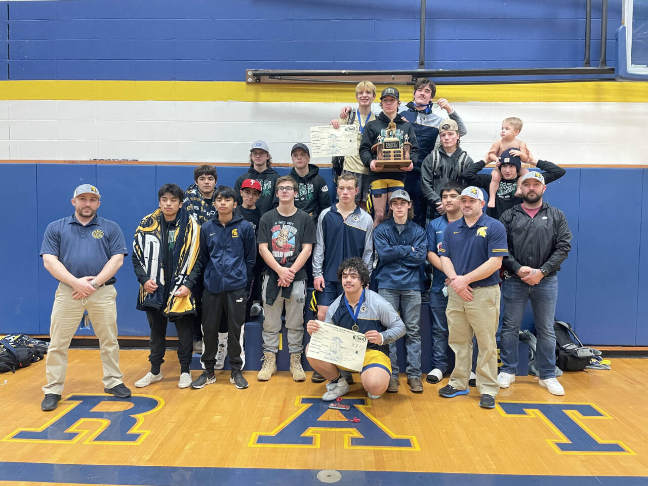 The Forks boys wrestling team celebrates winning the District 1 1B/2B Regional held in Adna this weekend. Forks had four weight division winners at regional — Jake Weakley, Hayden Queen, Sloan Tumaua and Conner Demorest. (Courtesy photo)