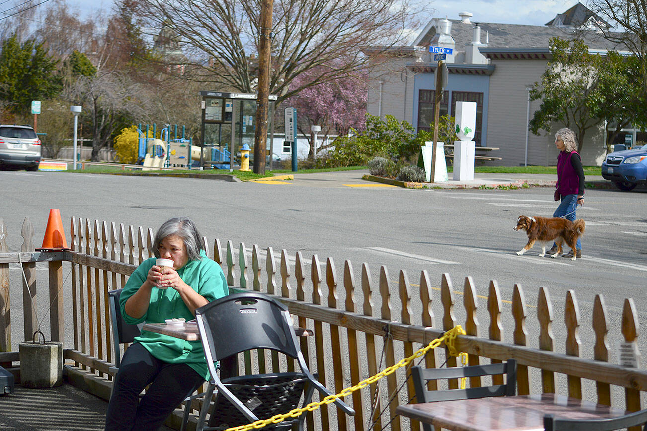 Kelly Toy of Port Townsend sips a beverage Tuesday afternoon at the Seal Dog Coffee-Uptown Pub streatery on Lawrence Street. The Port Townsend City Council is considering making the pandemic-spurred streatery program permanent. (Diane Urbani de la Paz/Peninsula Daily News)