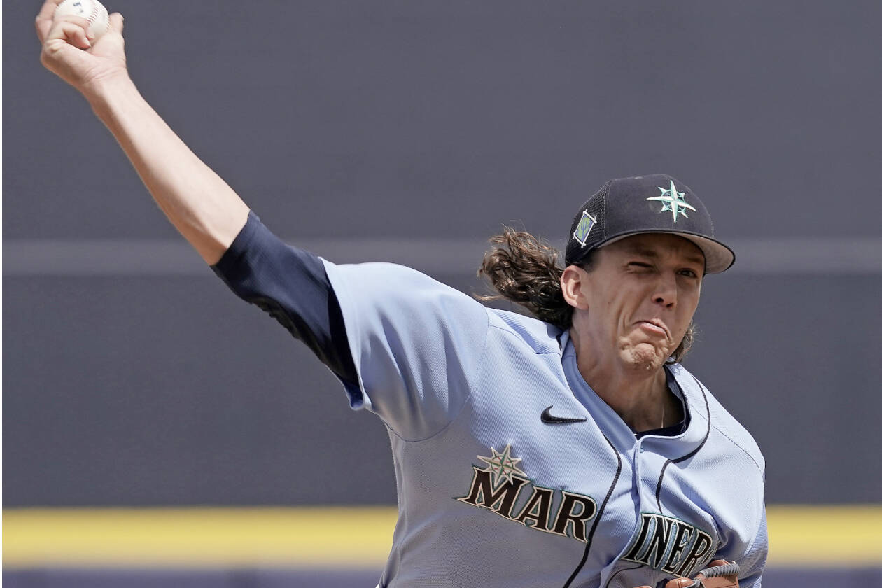 Seattle Mariners starting pitcher Logan Gilbert throws during the first inning of a spring training baseball game against the Kansas City Royals Tuesday, March 29, 2022, in Peoria, Ariz. (Charlie Riedel/The Associated Press)