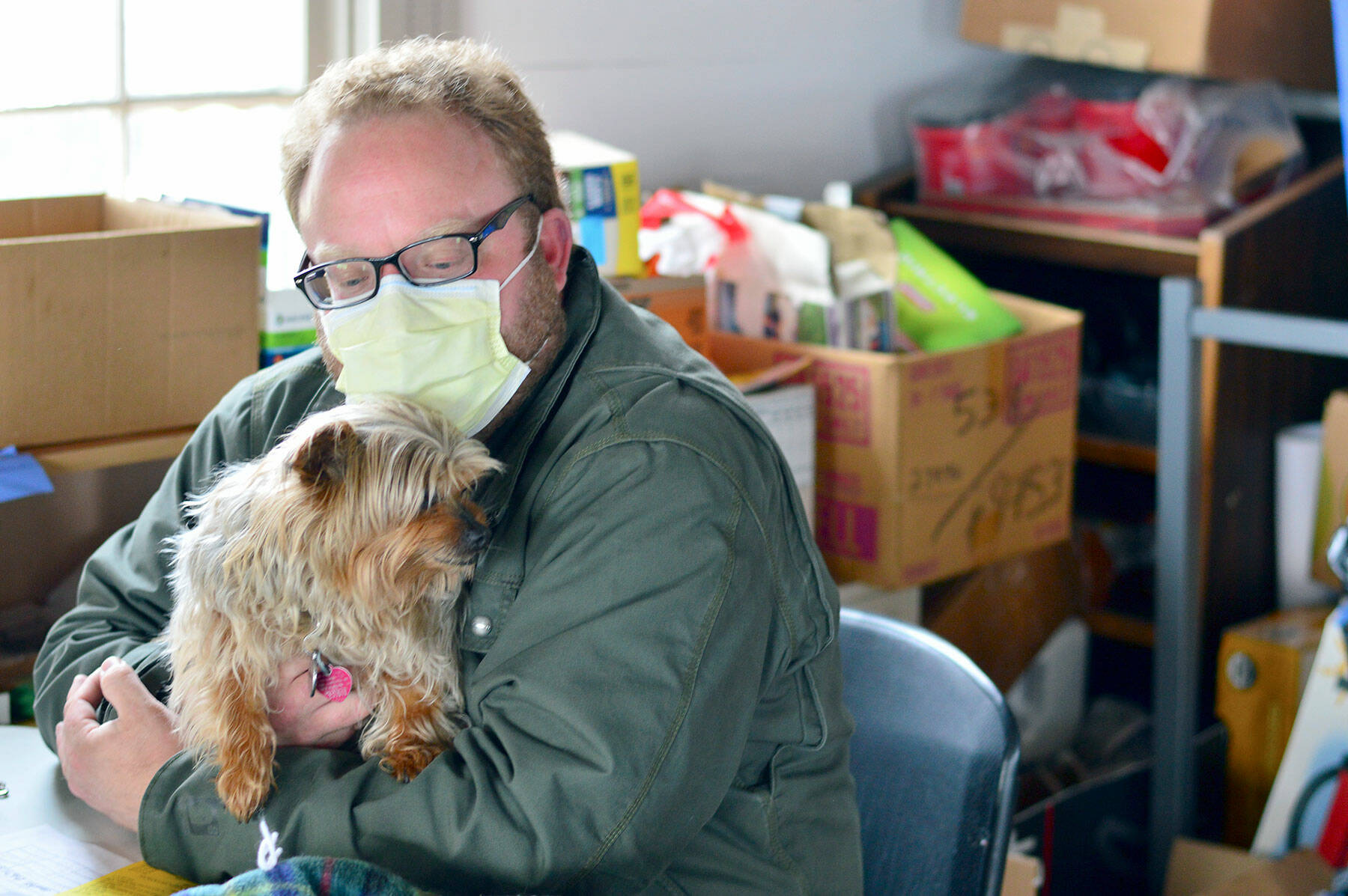 Ben Casserd keeps his terrier Half Pint close by as he manages downtown Port Townsend’s Winter Welcoming Center. (Diane Urbani de la Paz/Peninsula Daily News)