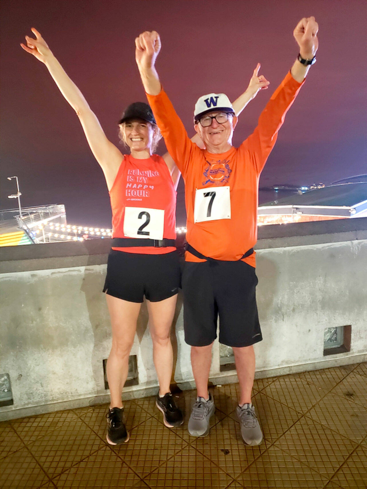 Alison Agness, left, and Port Angeles’ Bruce Skinner celebrate after completing a marathon in Lima, Peru over Memorial Day Weekend. Skinner has now completed his goal of running marathons on all seven continents. (Courtesy photo)