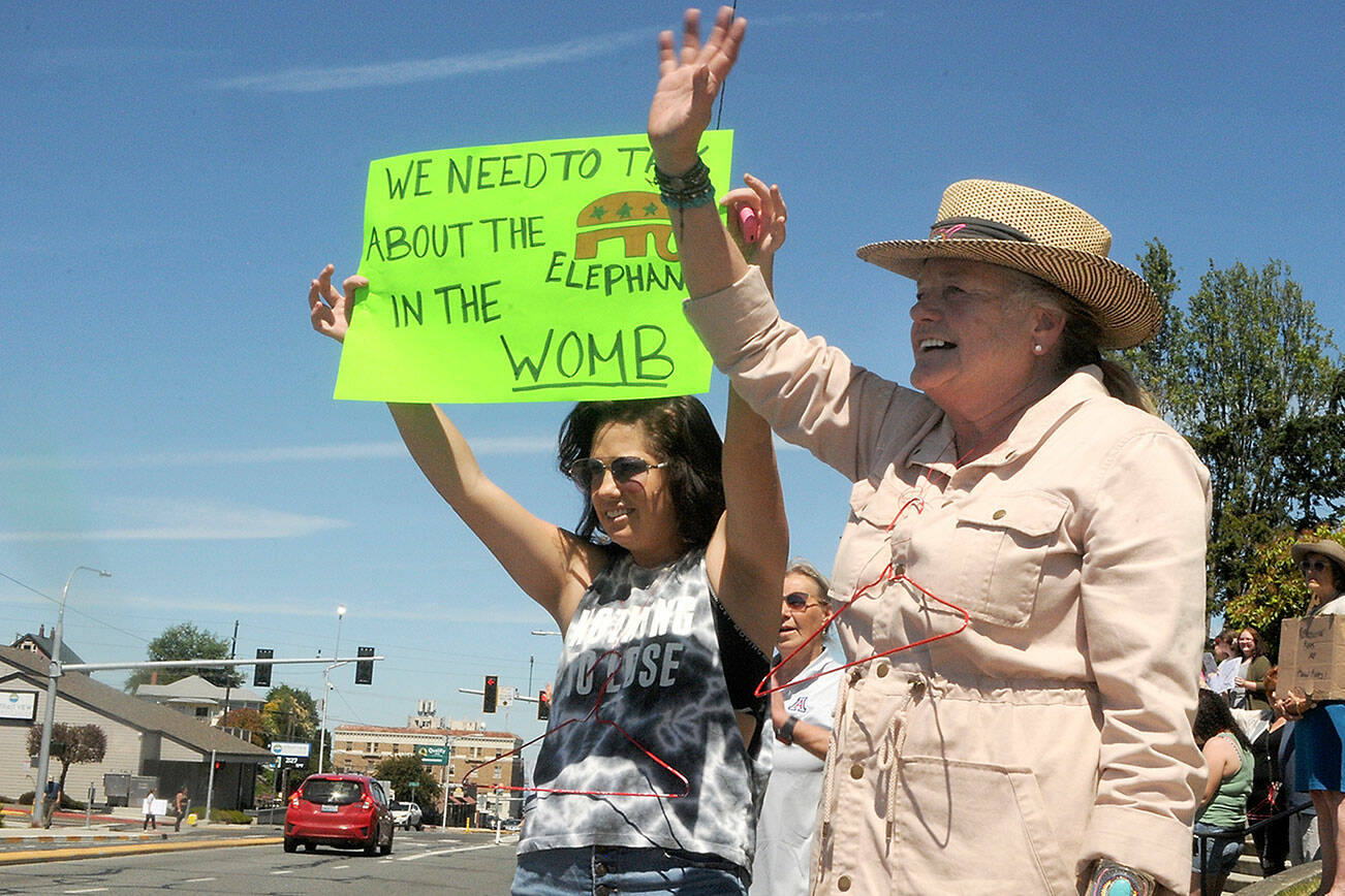 Hilary Soderling of Kirkland, left, and her mother, Lou Ann Soderling of Port Angeles, participate in Saturday’s rally at the Clallam County Courthouse. (Keith Thorpe/Peninsula Daily News)