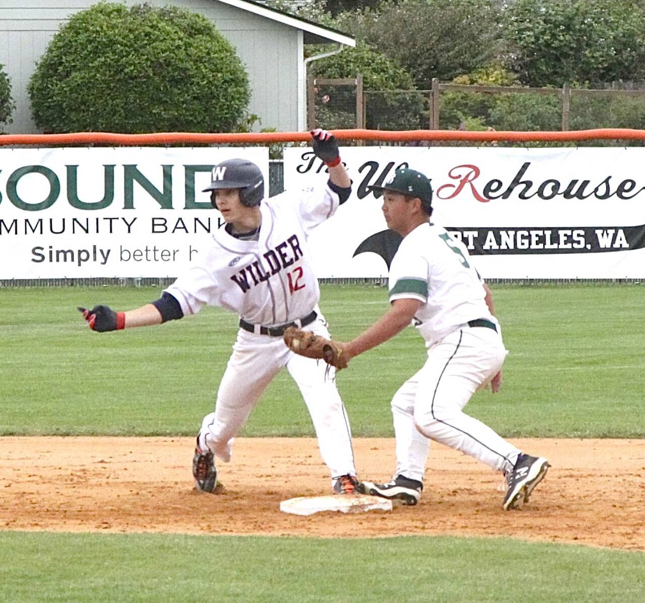 Wilder Senior’s Landon Seibel looks back at the umpire as he is called safe at second base as Lakeside BR’s Ethan Babauta puts the tag on Seibel on Sunday in the Dick Brown Memorial Tournament semifinal. Wilder Senior won 15-5 to advance to the championship game, which was won by WBC Colts Black. (Dave Logan/for Peninsula Daily News)