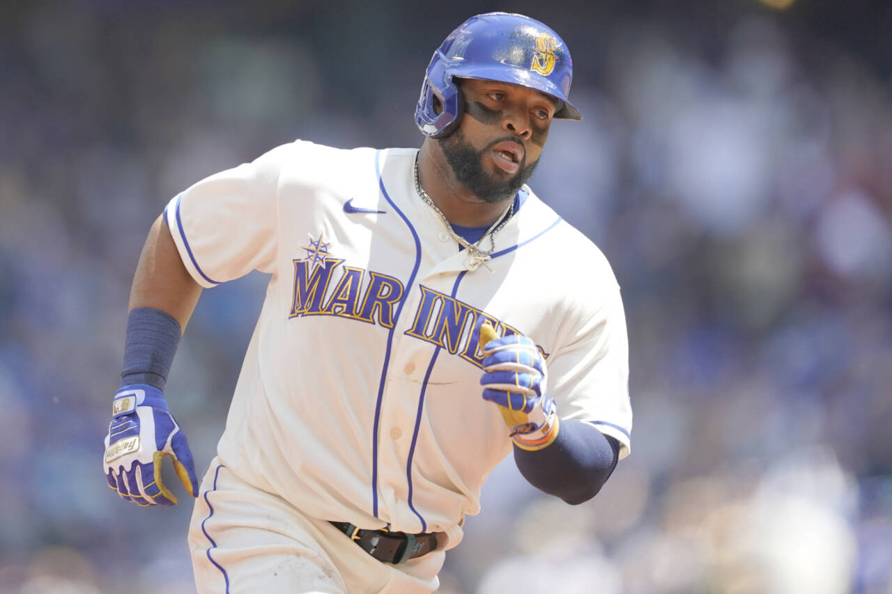 Seattle Mariners' Carlos Santana rounds the bases after he hit a solo home run against the Toronto Blue Jays during the second inning of a baseball game, Sunday, July 10, 2022, in Seattle. (AP Photo/Ted S. Warren)