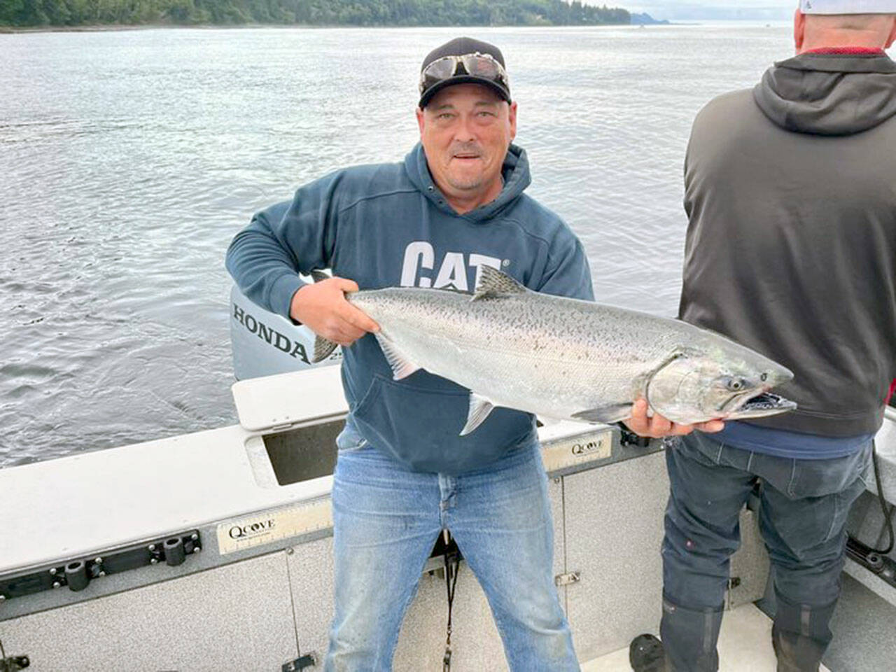 Port Angeles angler Justin Peterson landed this good-sized hatchery chinook while fishing just off shore at the Caves near Sekiu.