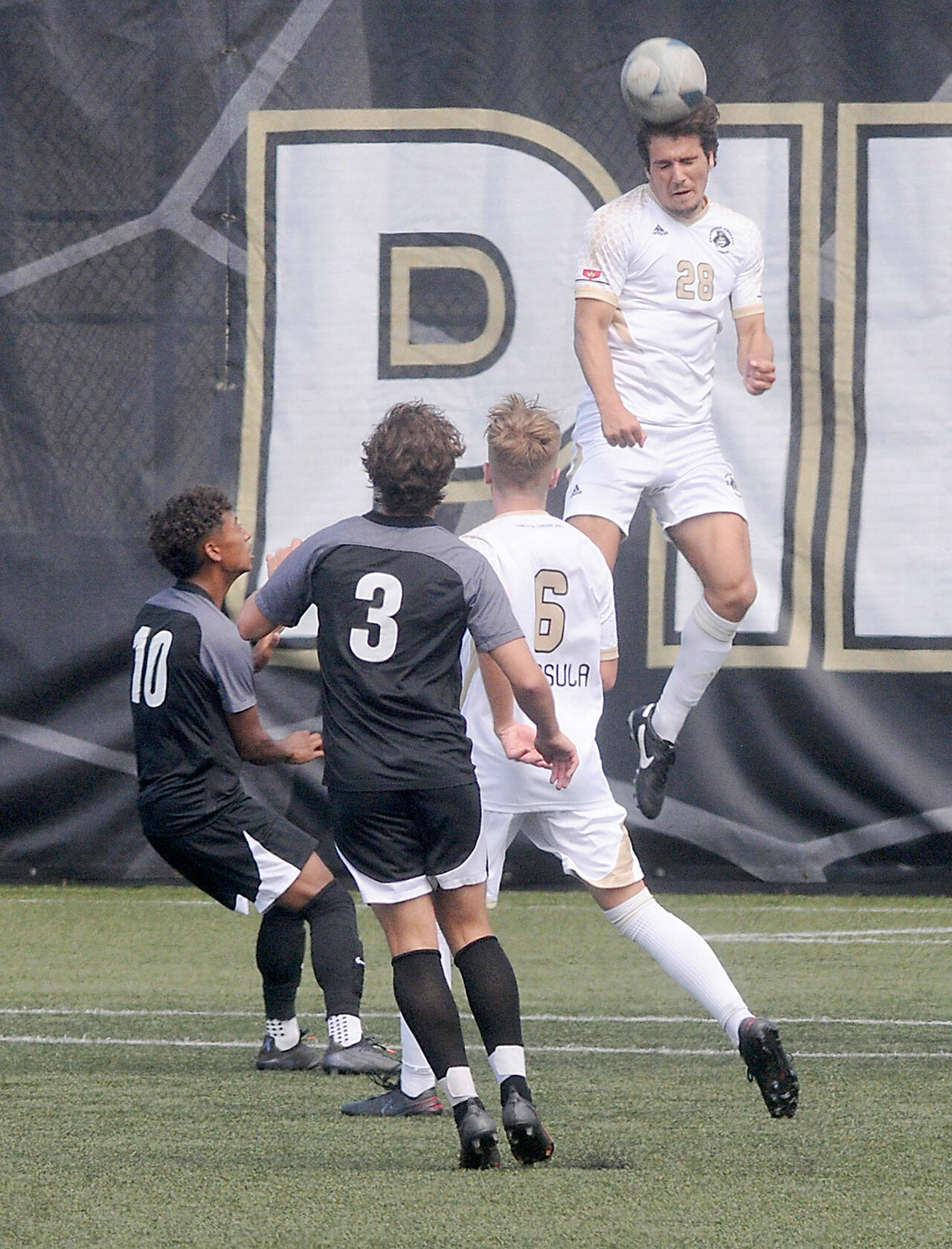 Keith Thorpe/Peninsula Daily News Peninsula’s Kai Biegler takes the header above Wenatchee Valley’s Diego Zaldivar, left, and Pierce Naccarato and Peninsula teammate Tim Deser on Thursday at Wally Sigmar Field.