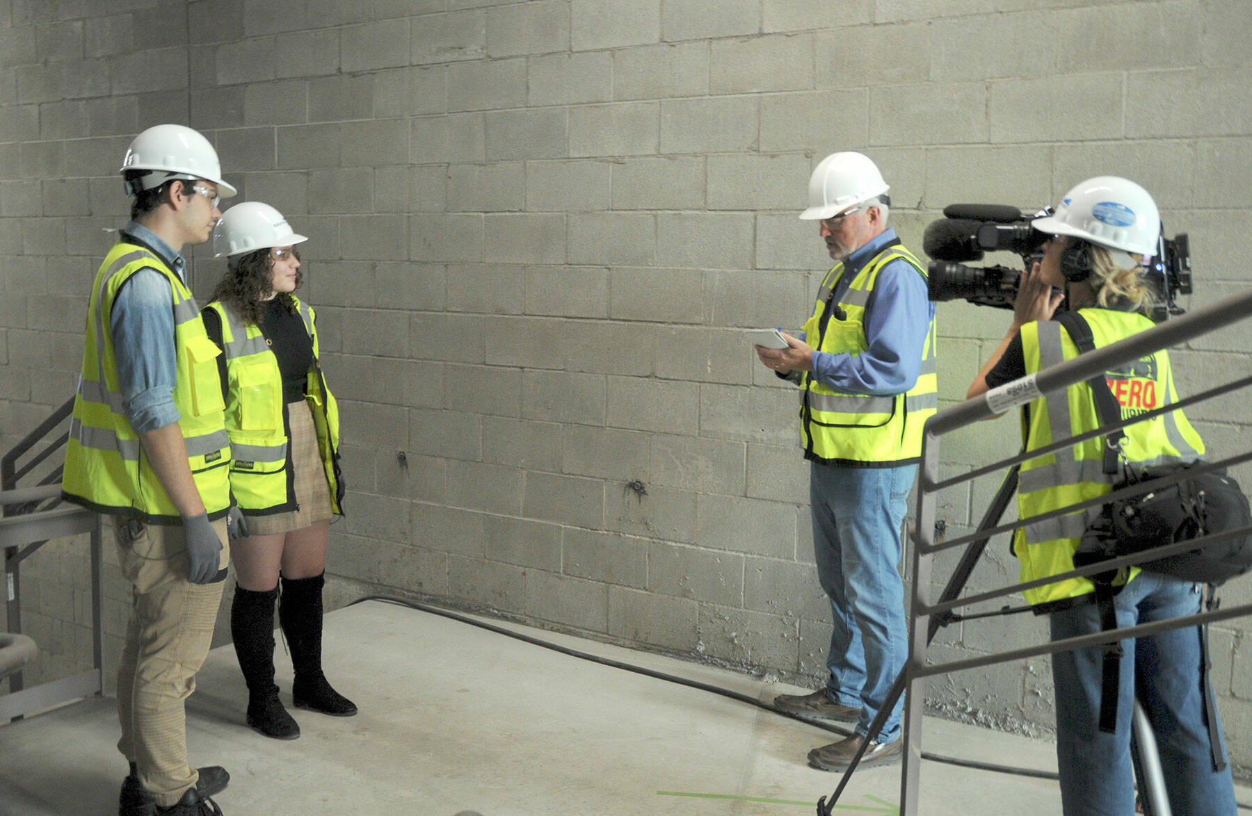 Peninsula College students Riley Baermann, left, and Avery Saul, both of Port Angeles, talk about their upcoming involvement in the Media Tech and Stagehand Training School with KING-5 television interviewer Eric Wilkinson and camera operator Robin Lile during a taping session at Field Arts & Events Hall on Thursday in Port Angeles. (Keith Thorpe/Peninsula Daily News)